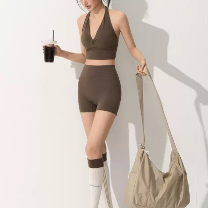 Custom yoga set manufacturer creating private label women's activewear with halter top and high waisted shorts