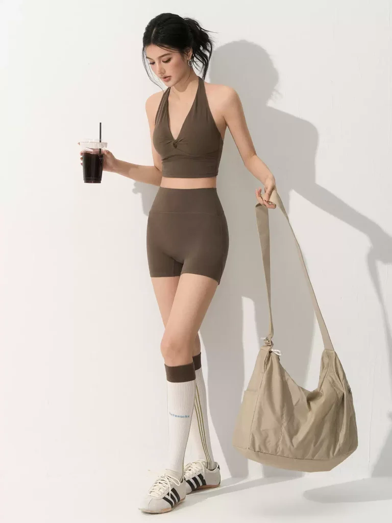 Custom yoga set manufacturer creating private label women's activewear with halter top and high waisted shorts